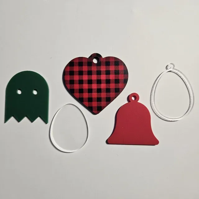 Various shapes cut from frosted acrylic, red and green dual finish acrylic, and plaid pattern plywood